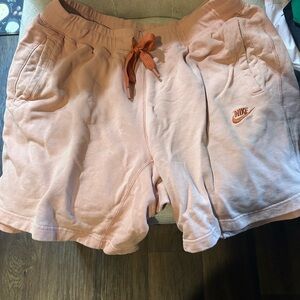 Nike Soft Pink Shorts with Orange Accent